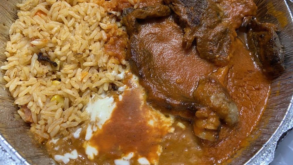Steak Ranchero · Steak with ranchero sauce, served with rice and beans.