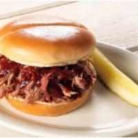 Pulled Pork Sandwich · Tender and juicy hickory-smoked pulled pork piled high on a Roma bun.