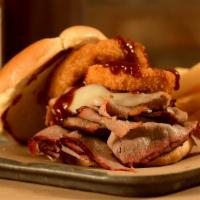 Average Joe Sandwich · Sliced beef and melted provolone topped with two onion rings on a toasted roma bun.