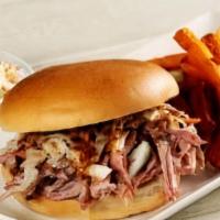 Sweet Carolina Sandwich · Tender and juicy hickory smoked pulled pork topped with tangy southern-style coleslaw and dr...