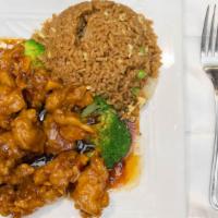 Orange Chicken · Served with vegetable fried rice or steamed rice and egg roll or two pieces of crab rangoon.