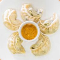 Momo Chili · Momo of choice fried with onion, green, red or yellow pepper with chili sauce.