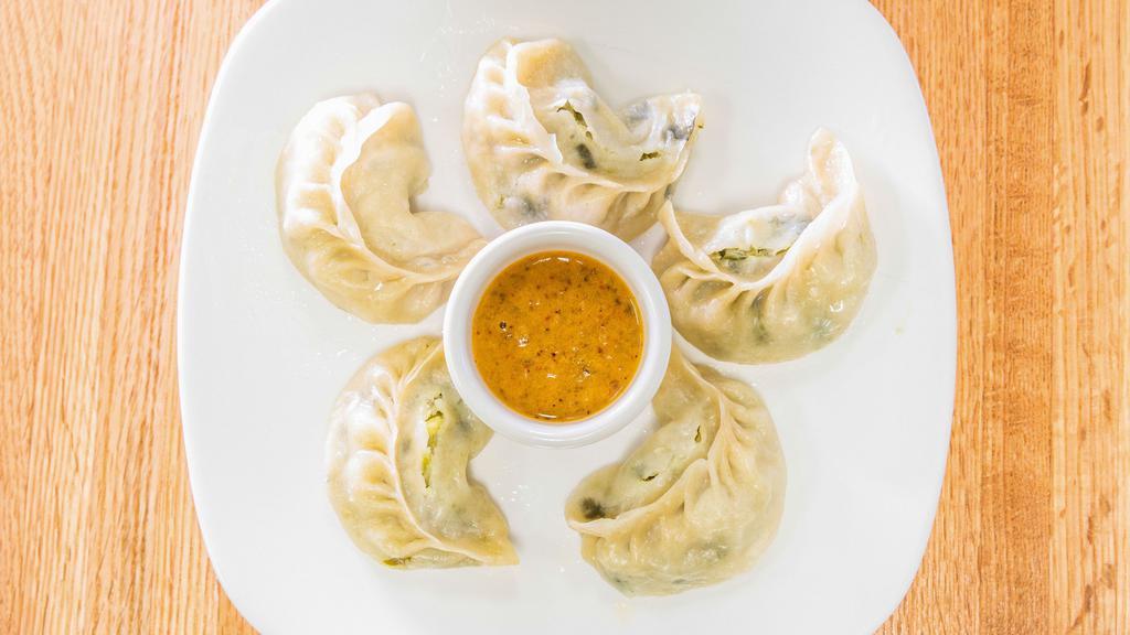 Momo Chili · Momo of choice fried with onion, green, red or yellow pepper with chili sauce.
