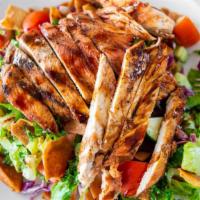 Fattoush Salad · Crisp romaine lettuce, sliced cucumber, tomatoes, and shredded red cabbage. Topped with frie...