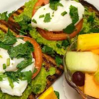 Avocado Toast · Multi grain toast, smashed avocado, tomato wheels, two poached eggs, cilantro and scallions.