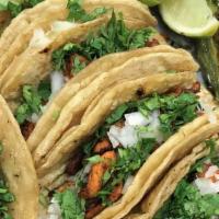 Tacos · Corn tortilla served with onions, cilantro, choice of meat.