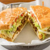Torta · Mexican sandwich served with mayo, beans, onions, tomatoes, lettuce, jalapeños and cheese.