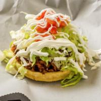 Sopes · Round corn tortilla, topped with beans, fresco cheese, lettuce, tomatoes, sour cream and cho...
