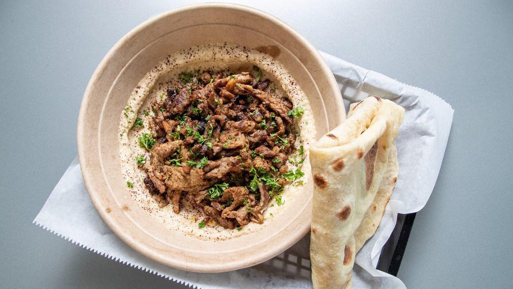 Steak Shawarma · comes with rice on the base, with our steak marinated in the shawarma seasoning, topped with our four main garnishes and our recommended tahini sauce