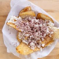 Greek Fries · Topped with feta cheese olive oil sumac seasoning and parsley. with our signature garlic sau...