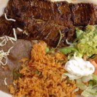 Carne Asada · A Skirt Steak Dinner - With rice, beans, lettuce, tomatoes, sour cream and tortillas.