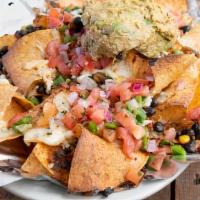 Nachos · Fried white-corn tortilla chips topped with veggie black-bean mix, white cheese blend, house...
