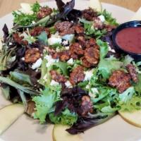 Apple And Candied Walnut Salad · Organic leaf lettuce with candied walnut halves, apples, and feta cheese with a side of rasp...