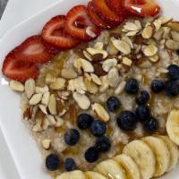 Loaded Oats · Oatmeal, strawberry, blueberry, banana, sliced almonds and honey drizzle.
