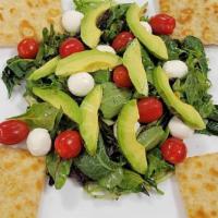 The Caprese Salad · Mixed greens, avocado, fresh mozzarella, cherry tomatoes tossed in balsamic vinaigrette.