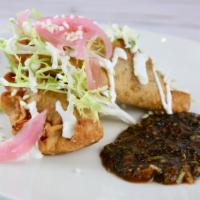 Empanadas · Two turnovers, served with frisee, queso 
cotija, crema mexicana, choice of ground beef pica...