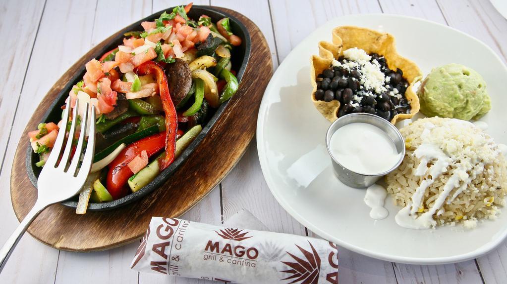 Fajita Vegetarianas (Gf) · Sautéed green and red peppers, spanish onions, zucchini, portabello mushrooms, roasted poblano peppers. Served with sour cream, guacamole, pico de gallo, rice and beans, and choice of corn or flour tortilla