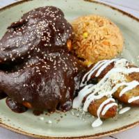 Pechuga En Mole Xico · Orange mojo marinated chicken slow roasted with mole xico, Mexican rice and sweet plantains.