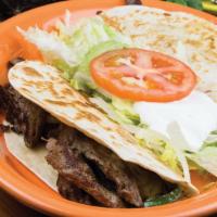 Quesadilla Fajita · 2 Quesadillas  with Chicken or steak strips with grilled onions, bell peppers and tomatoes s...