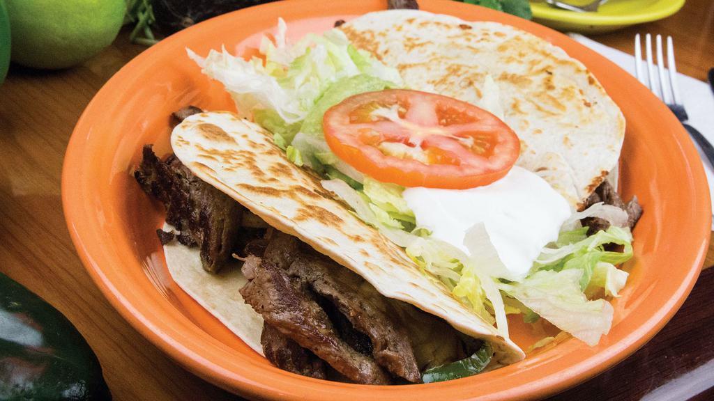 Quesadilla Fajita · 2 Quesadillas  with Chicken or steak strips with grilled onions, bell peppers and tomatoes served with a side of lettuce, guacamole, sour cream and tomatoes