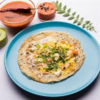 The Egg Dosa · Exquisite Thin Crepes Made From Rice & Lentil topped with eggs coated on top. Served with Sa...