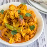 The Aloo Gobi · Cauliflower And Potatoes Cooked To Perfection With Mild Indian Spices, Tomatoes And Herbs. S...
