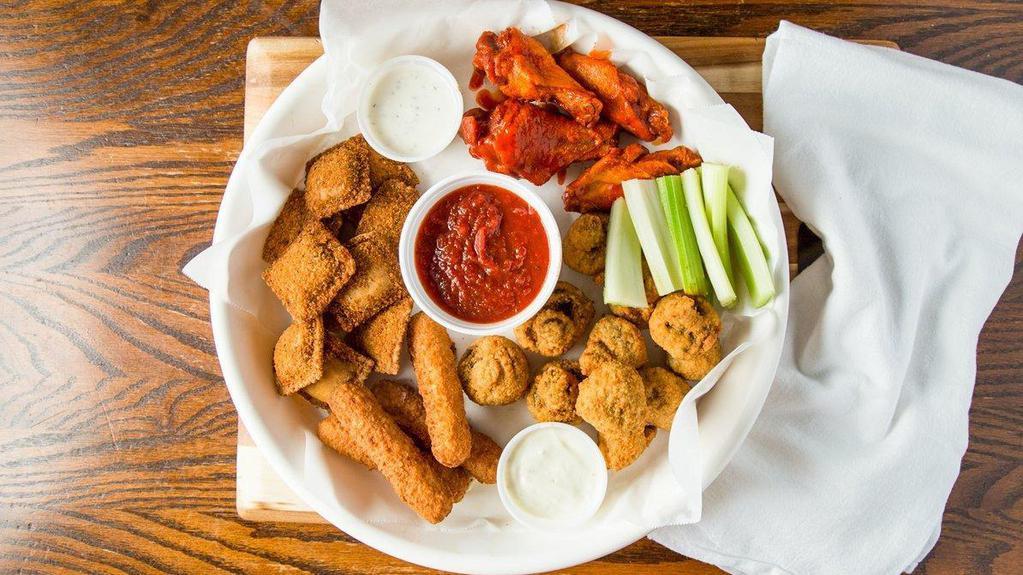 Flea Market Sampler · A giant combination of wings, mushrooms, mozzarella bites, and ravioli. Served with our homemade tomato sauce, ranch, and celery.