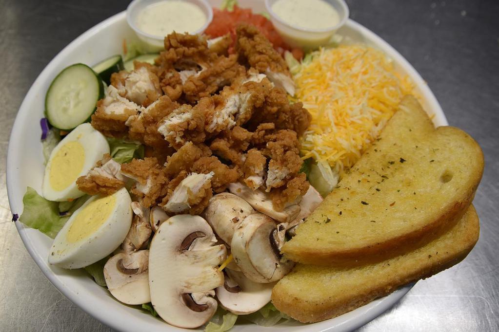 Fried Chicken Breast Salad · Chicken breast fried golden brown and served atop iceberg lettuce, tomato, cucumber, mushrooms, eggs, and mixed cheese. Served with Parmesan garlic Texas toast.