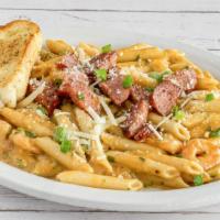 Spicy Shrimp Pasta · Spicy Shrimp Alfredo Served over Penne Pasta, Topped with Chopped Sausage & Served with Garl...