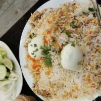 Chicken Biryani · Long grain basmati rice with aromatic spices with flavorful steamed chicken.
