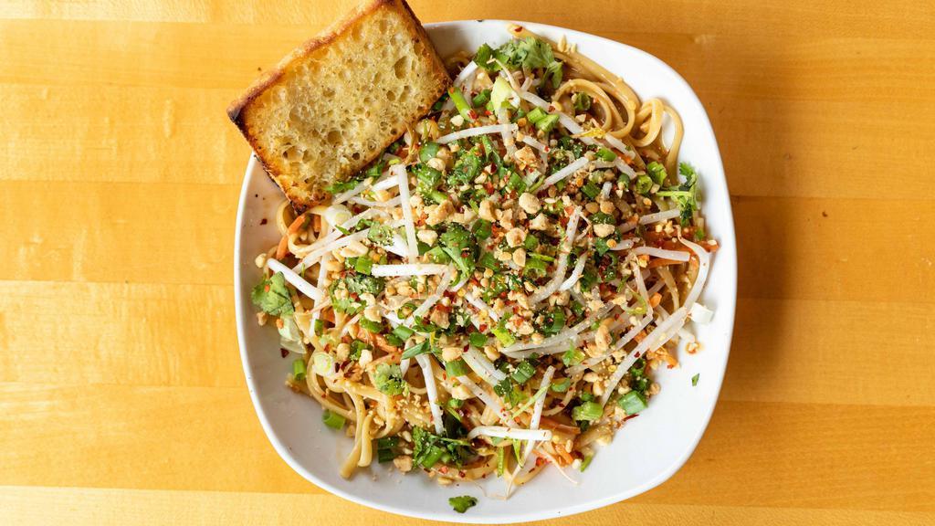 Thai Peanut Linguine · Linguine noodles tossed with organic carrots, fresh bean sprouts, and our homemade Thai peanut sauce (contains gluten). Topped with organic cilantro, organic green onions, peanuts, and hot chili flakes. Regular pasta comes with garlic bread.