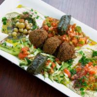 Vegetarian Plate · Hummus, baba ghanouj, choice of two salads, 3 falafels, and 2 grape leaves with two pitas.