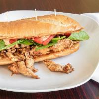 Sautéed Chicken Po Boy Sandwich · A Louisiana-style sandwich with a buttery toasted French loaf, lettuce, tomato, and a mayonn...