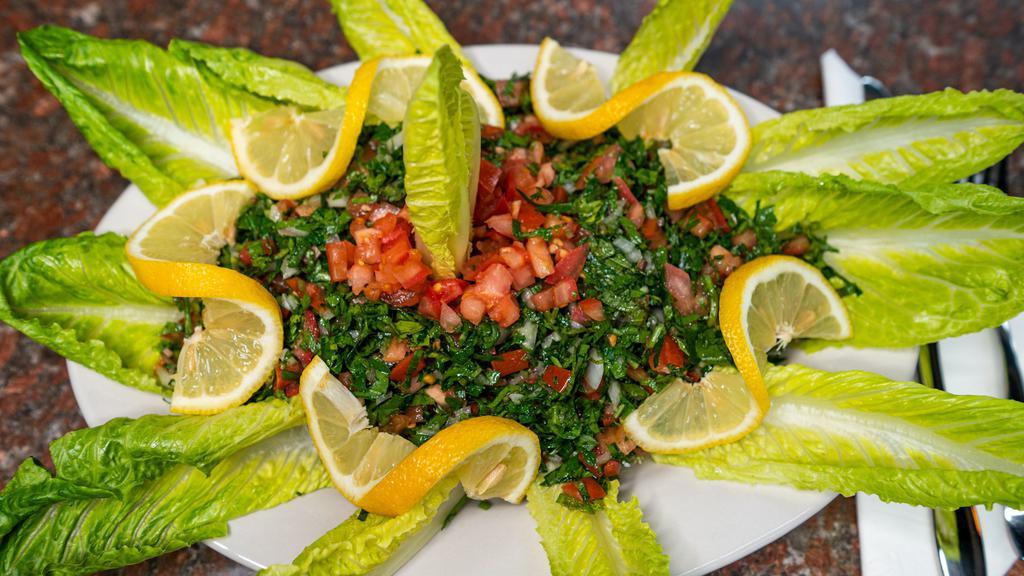 Tabbouli Salad · Parsley mixed with diced tomato, green onion, burghul wheat, and tossed in traditional love dressing.