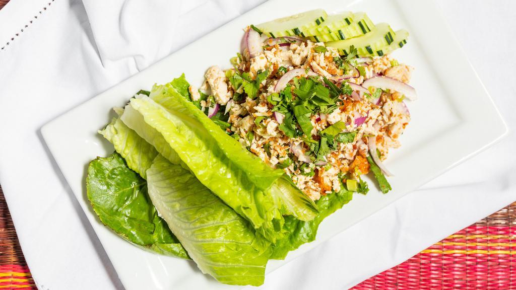 #14. Larb · Your choice of ground beef or chicken with lemon juice, chili, green onions, and crushed toasted rice, served with cucumber and fresh lettuce.