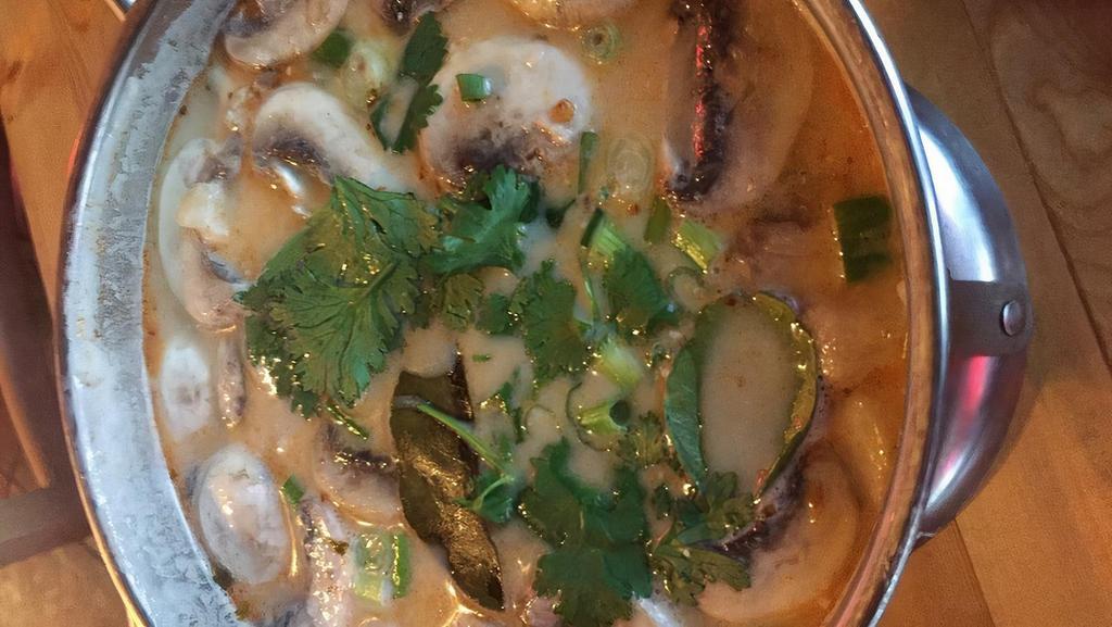 #17. Chicken Or Vegetable Tohm Kha · Chicken or vegetable cream soup, flavored with coconut milk galangal, lime juice, and straw mushrooms.