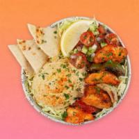 Chicken Kebab Hummus Bowl · Grilled chicken over hummus, diced cucumber and tomato salad, shredded green cabbage and a d...
