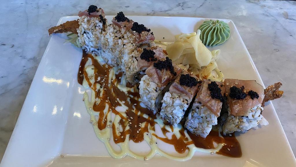 Mother Of Dragons Roll · Shrimp tempura, cucumber, and spicy tuna topped with seared tuna, tobiko, wasabi aioli, spicy kimchee sauce and eel sauce in a nori wrap with a side of pickled white ginger and wasabi.
