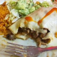 Burrito Supreme · Beef or shredded chicken burrito topped with lettuce, tomato and sour cream. Served with ric...
