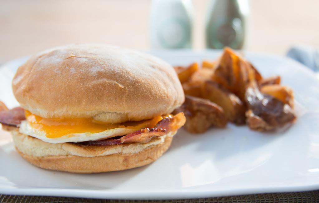 Breakfast Sandwich · 1 over easy Gast farm egg, cheddar or American cheese, chile mayo, on a toasted potato roll. Served with home fries.