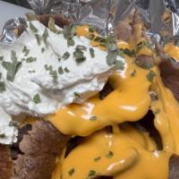 Gyro Potato · Baked potato topped with gyro, melted cheddar cheese, sour cream, and chives.