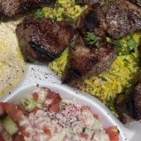 Lamb Shish Kabab Platter · Two skewers of lamb marinated in our own special recipe. Served with rice, HUMMAS and a sala...