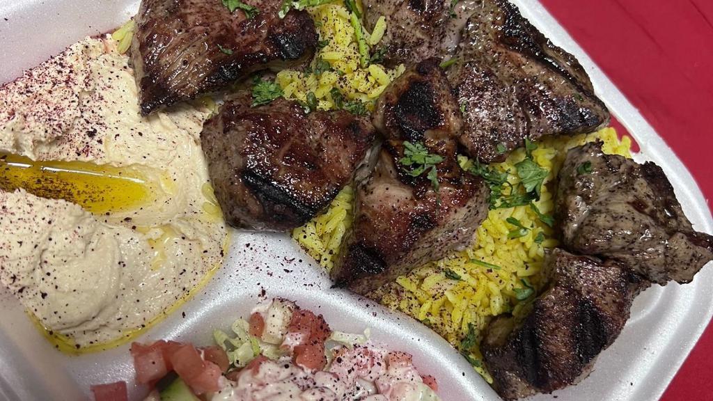 Beef Kabab Platter · Two skewers of beef marinated in our own special recipe. Served with rice, HUMMAS and salad mix.