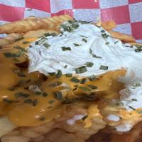 Loaded Fries · Large fries topped with melted nachos cheese sauce, sour cream, and chives.