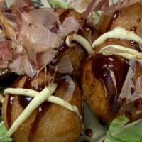 Takoyaki · Fried Japanese octopus balls, kewpie mayo, sweet sauce, bonito flakes, nori shredded.