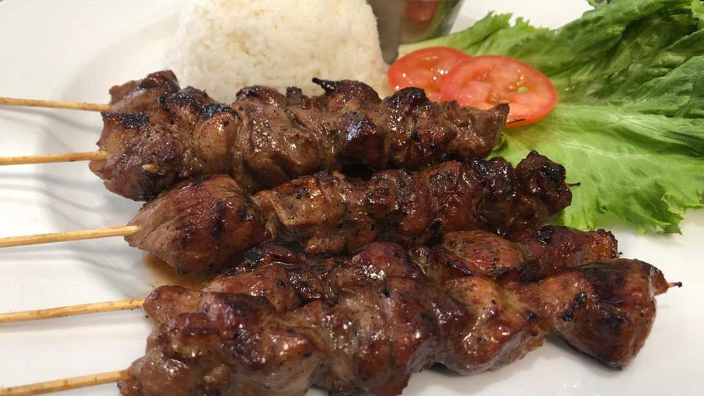 Sate Kambing · Grilled lamb-on-skewer. Served with rice and peanut-sauce.
