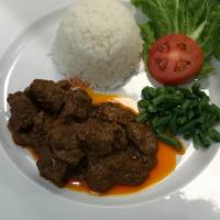 Beef Rendang · Slow and longer cooked beef in coconut milk with rendang spices. Served with fried egg and v...
