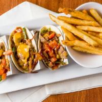 Steak Tacos  · steak , quacamole, grilled onion peppers  and tomatoes  and cheddar cheese