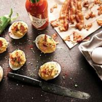 Deviled Eggs · Topped with bacon, jalapeños and paprika