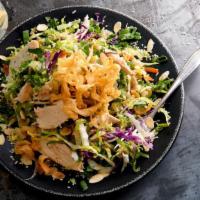 Chinese Chicken Salad · Grilled chicken, Napa cabbage and romaine lettuce, crunchy noodles, almonds, sesame seeds, g...